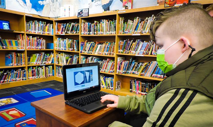 Students on laptops in the library